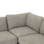 Corner seat cushion and back cushions meeting at right angle with soft gray fabric