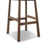 Close-up of wooden legs and crossbar footrest showing natural wood grain and finish