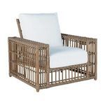 Outdoor woven recliner chair with light brown frame and white cushions