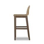 Side profile of bar stool highlighting curved woven backrest and wooden frame
