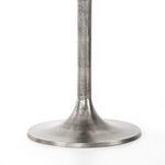 Close-up detail of tulip base texture showing brushed and weathered nickel metal