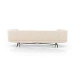 Rear view of sofa showcasing curved back and black stainless steel legs with stretcher bars