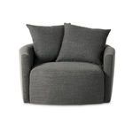 Corner angle showing armrest curve blending into wide rounded seat cushion