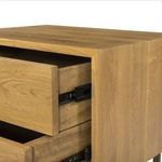 Partial open drawers showing interior wood and metal rails in darker stained nightstand
