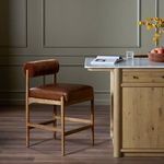 Jazelle Havana Brown Counter Stool styled next to kitchen island with marble countertop and wooden cabinetry