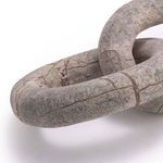 Close-up showing smooth marble texture and brown veining on curved chain link