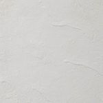 Very close detail of plaster-textured white surface with natural subtle ridges
