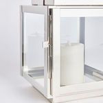 Close-up of chrome latch mechanism on outdoor lantern door with visible clear glass pane