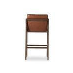 Back view close-up of stool highlighting leather back panel and wood frame joints