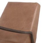 Back view of warm brown leather recliner with visible vertical seams