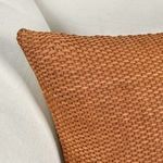 Close-up on corner of basket weave suede pillow emphasizing soft texture and fabric detail