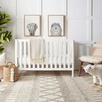 Similar nursery view showing woven baskets closer to window with wooden blocks on rug