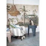 Valencia Beaded Chandelier hanging in a room with tropical mural, striped chair, side table, and plants