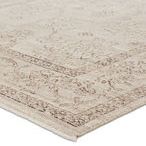 Close-up angle showing low pile texture and woven edge detail of Camille floral gray and brown rug