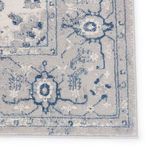 Close-up of corner detailing with visible floral motifs and clean hemmed edges in soft blue and gray tones