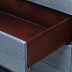 Interior of opened drawer showing reddish-brown wood contrast to navy blue exterior