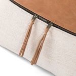 Close-up of leather zipper pulls and metal zipper on beige linen fabric panel