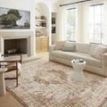 Living room with fireplace and sofa showcasing full layout of Sorrento Mocha rug