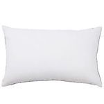 Back of pillow showing solid cream fabric with black stitched edges