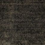 Folded corner with backing visible on a darker version of the Blanton Outdoor Rug