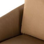 Close-up on top corner of back cushion with soft leather wrinkles