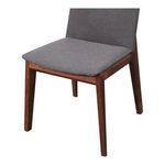 Close-up angled view focusing on the padded seat cushion and walnut frame legs of Deco Dining Chair.