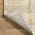 Rug corner flipped to expose underside, showing woven backing and neat edge finishing
