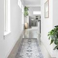 Skye Silver/Grey runner rug in bright hallway with polished concrete floor and potted plants