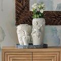 Close view of Daisy Maria vase trio styled with flowers on blue tray against textured wall