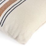 Close view of pillow corner showing plain cream fabric texture and subtle seam stitching