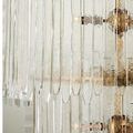 Detail of the textured clear glass bars showing subtle waviness against brass metal ring