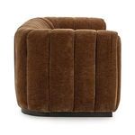 Side profile highlighting the sofa’s deep channel tufting and thick padded armrest