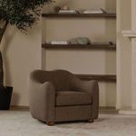 Bria Accent Chair placed in living room context with shelves, plant, and neutral wall background