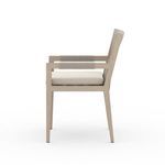 Side view emphasizing rope wrapping on armrest and wooden chair frame against white background