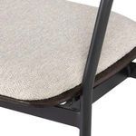 Close-up of the textured beige fabric seat and edge wooden trim of Gianni Counter Stool