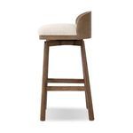 Side view of stool showing curved wood back wrapping around the seat