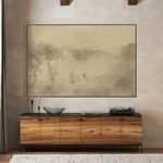 Alternate view of painting above wooden sideboard showing full room context with rug and candle decor on sideboard