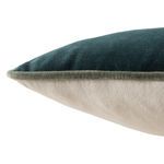 Close-up showing texture contrast between teal velvet front and cream fabric back with piped edge