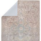 Upper corner of rug folded over revealing a light blue backing