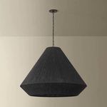 Keats Pendant shown hanging in room against beige wall, providing context for scale and setting