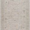 Round traditional woven rug in light gray with subtle art-inspired patterns in soft tonal hues
