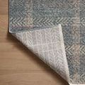 Corner flipped over showcasing woven backing grid pattern contrasting front design