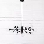 Chandelier suspended from ceiling viewed from below showing pendant rod and central iron cylinder