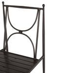 Close-up of wrought aluminum backrest with curved designs and ball finials in dark finish