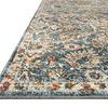Close-up angled view showing texture and edge binding of traditional blue and sand rug