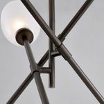 Close-up of black brass intersecting rods and frosted shade bases from below