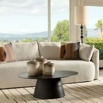 Karla Floor Lamp positioned beside cream boucle sofa with geometric pillows in a bright room overlooking greenery