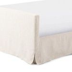 Back view of queen bed footboard slipcover with gently draped fabric and floor-length skirt