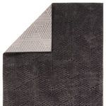 Back corner folded to reveal contrasting reverse side with lighter geometric pattern