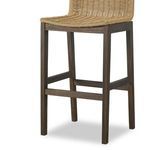 Lower angled view of stool legs and footrest with teak wood finish